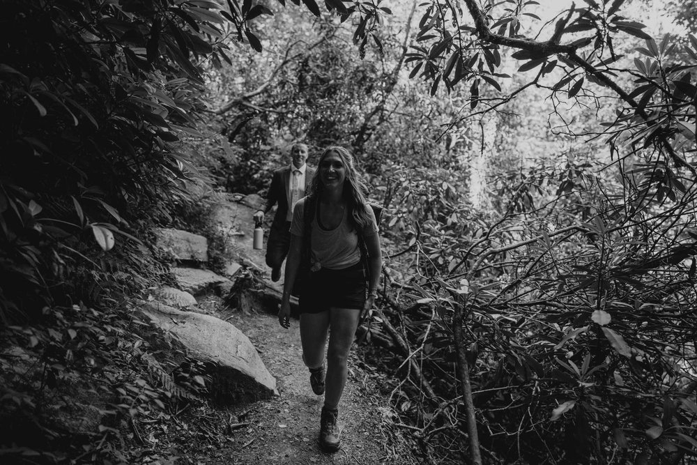 Kaitlyn and Evan hiking through the forest during their North Carolina elopement