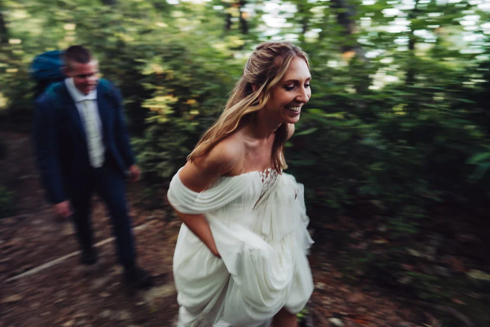 Kaitlyn laughing while hiking with Evan through the forest in Linville Gorge