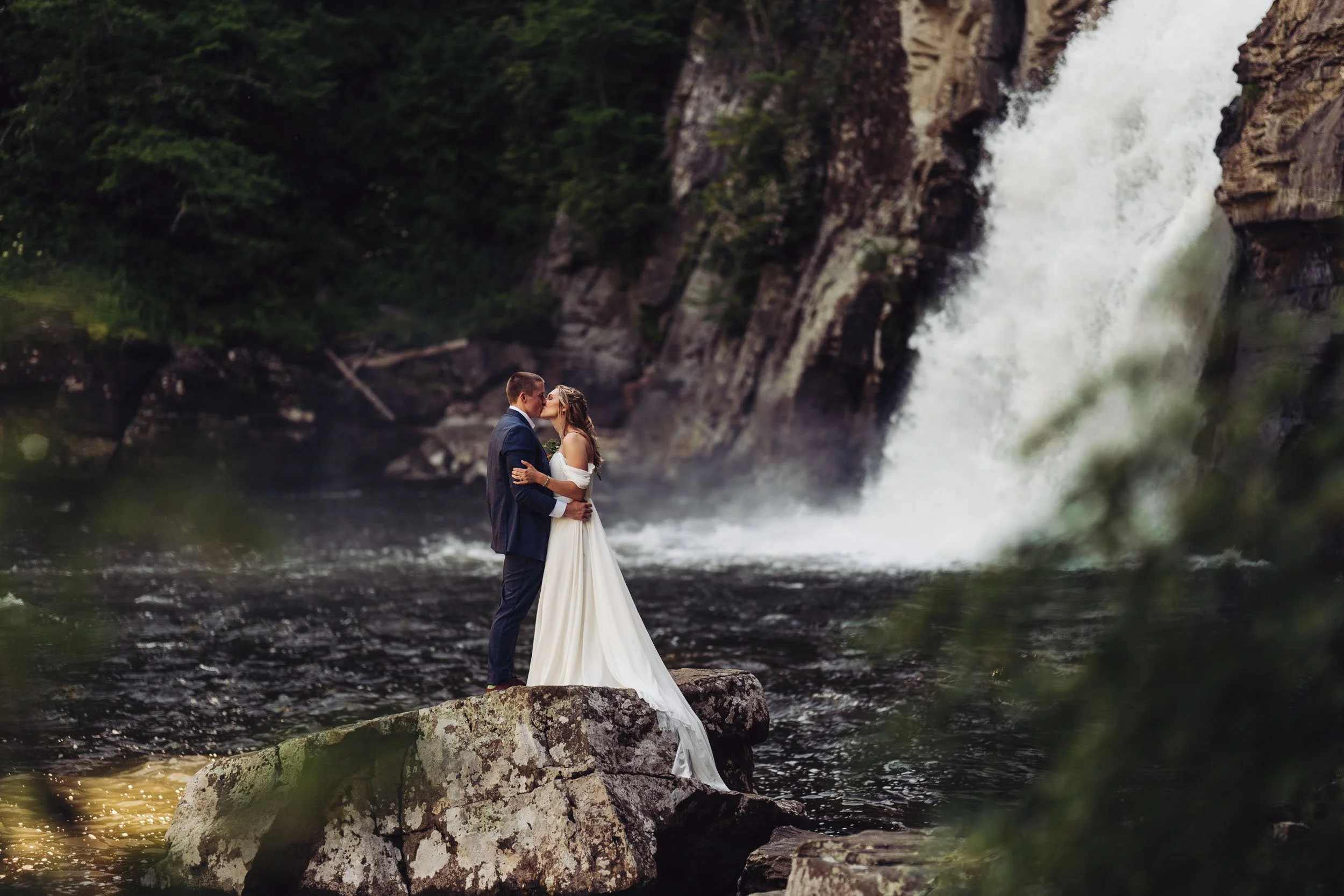 bride-and-groom-kissing-by-waterfall-romantic-wedding-scene.jpg
