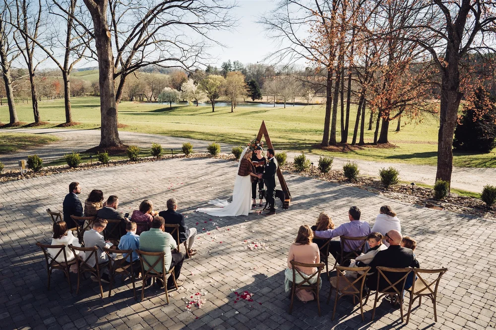 Intimate outdoor wedding ceremony with family and friends