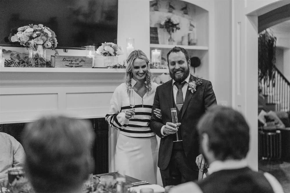 Couple listening to a toast during a small wedding reception