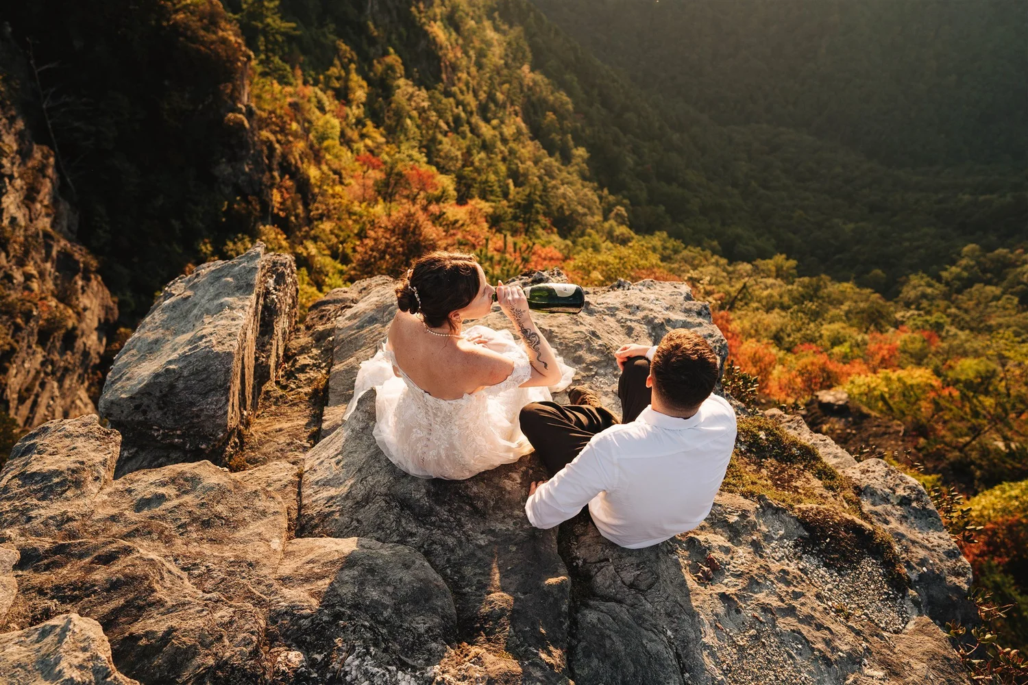 Wedding couple sharing a picnic at a mountain overlook near Asheville at sunset
