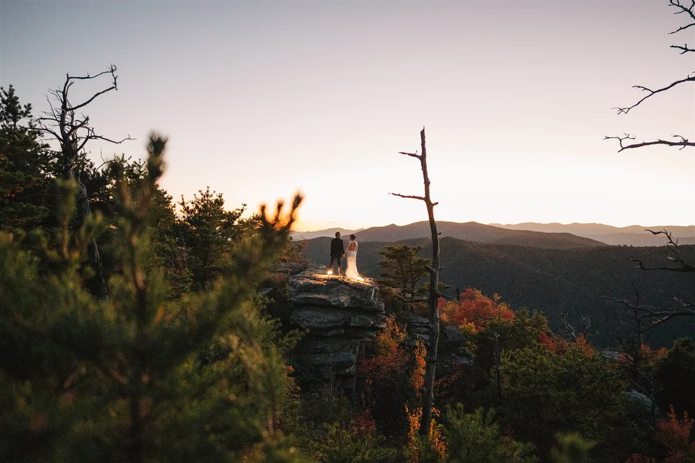 Couple walking together after their sunset mountain elopement