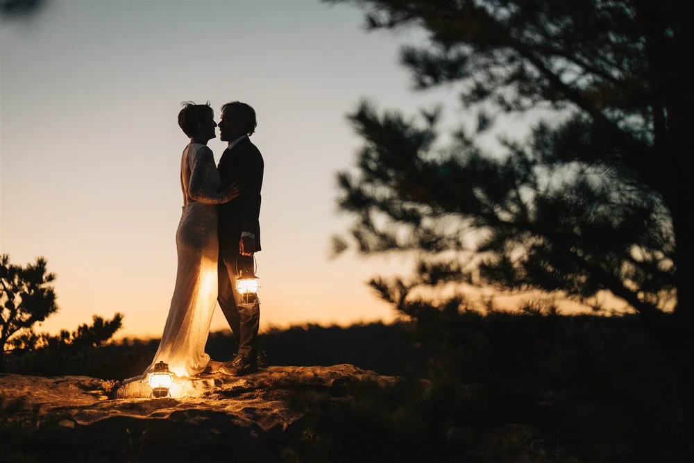 Sunset lantern silhouette after a mountain elopement
