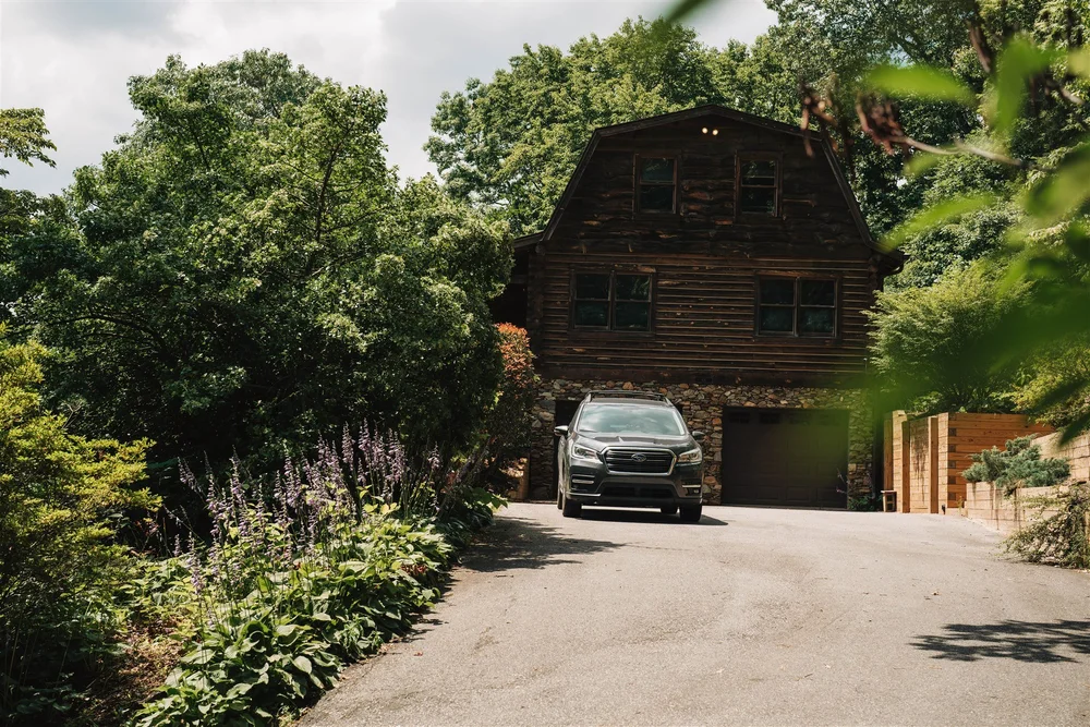 Wedding couple outside a mountain cabin before an adventure elopement