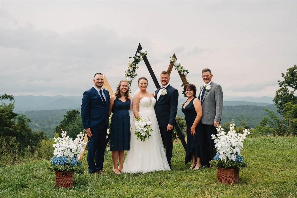 Newly married couple with family at a small mountain wedding