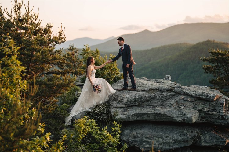 Couple standing together at a wide mountain overlook in Western North Carolina
