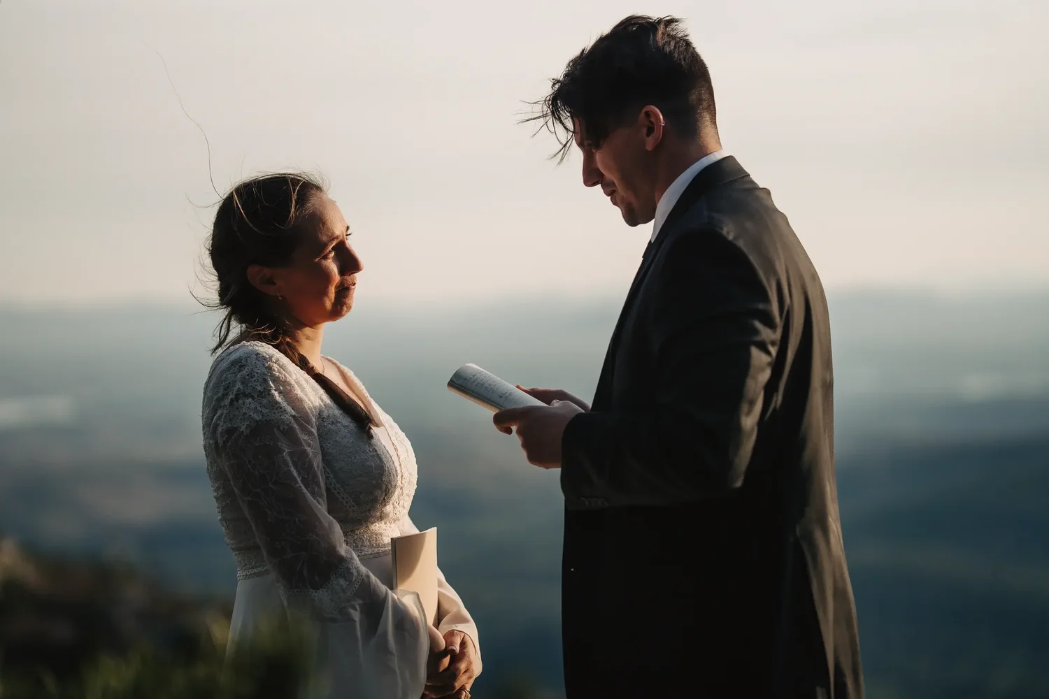 Couple exchanging private vows on a mountain overlook