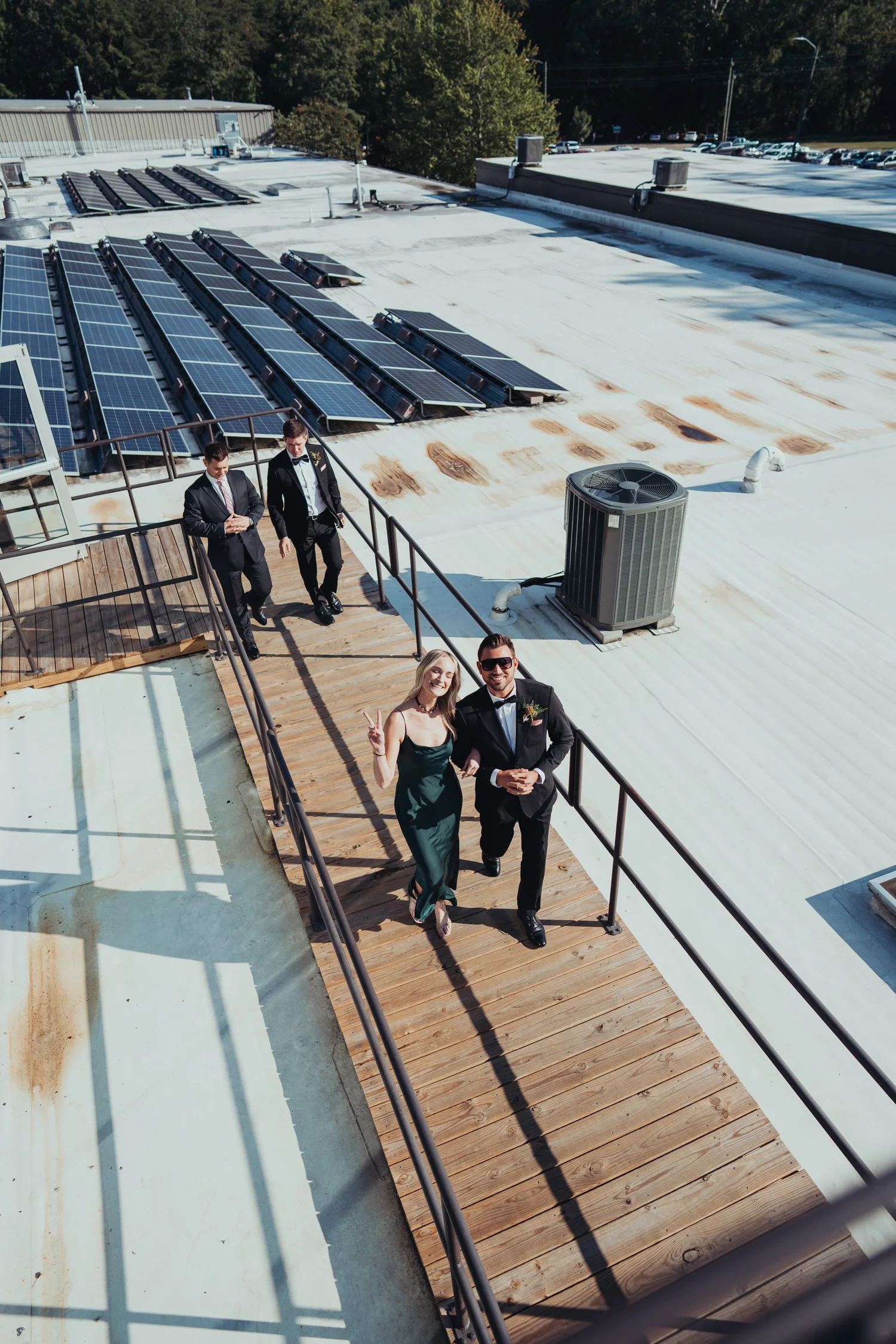Wedding party walking across the rooftop of an industrial wedding venue in Asheville
