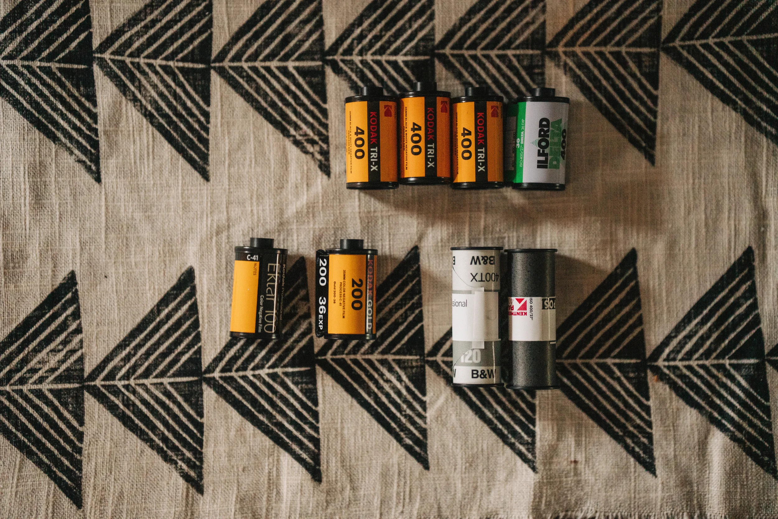 Rolls of film lined up on a table cloth.