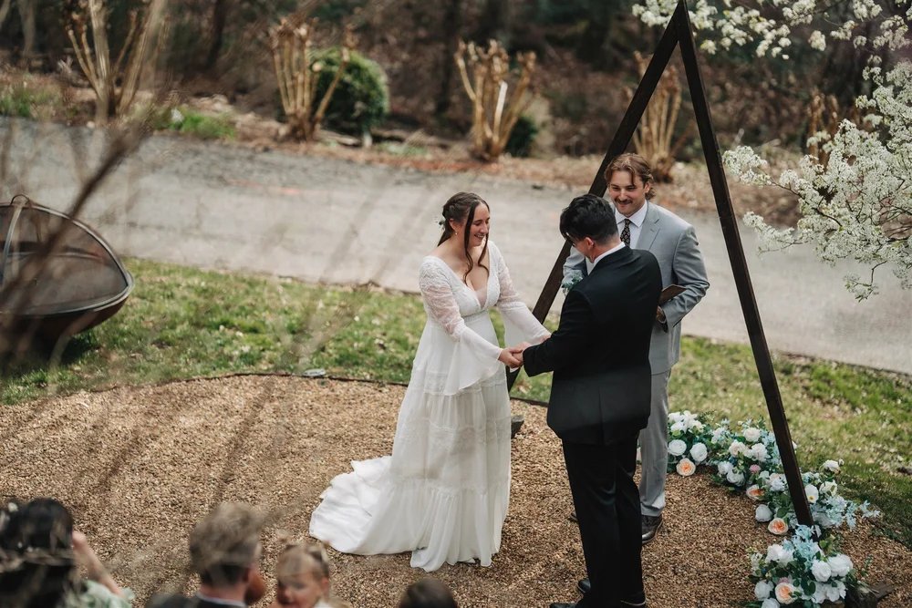 Couple exchanging vows during a small outdoor wedding ceremony