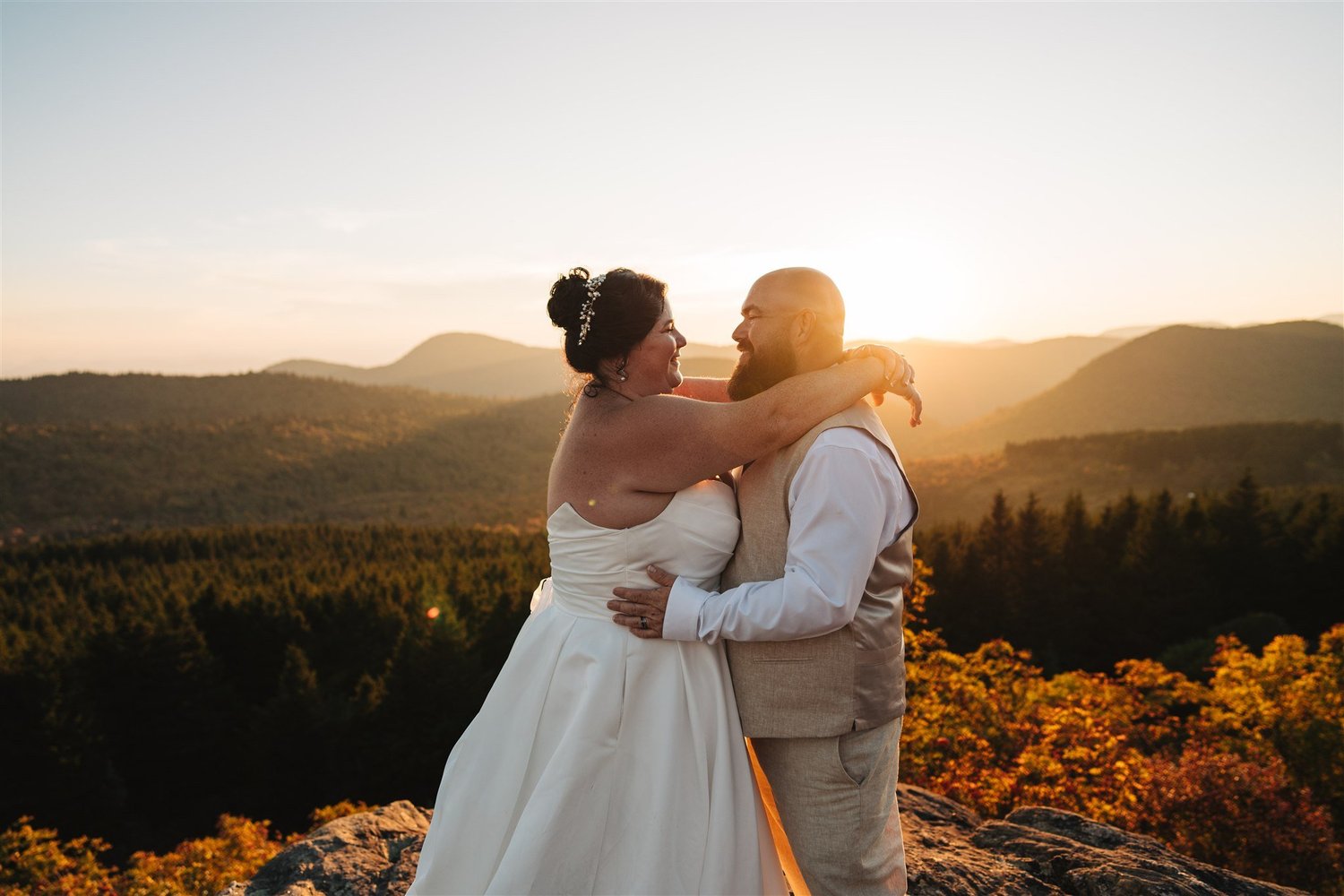 Newlyweds embracing during sunset portraits in the Blue Ridge Mountains