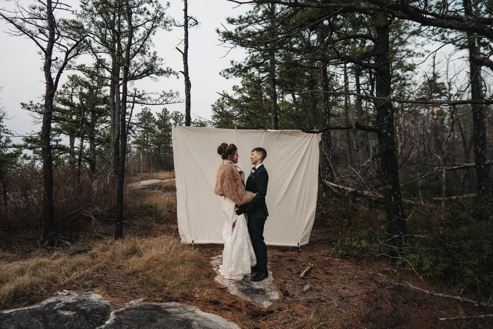 Couple together during an intimate wedding celebration in the forest