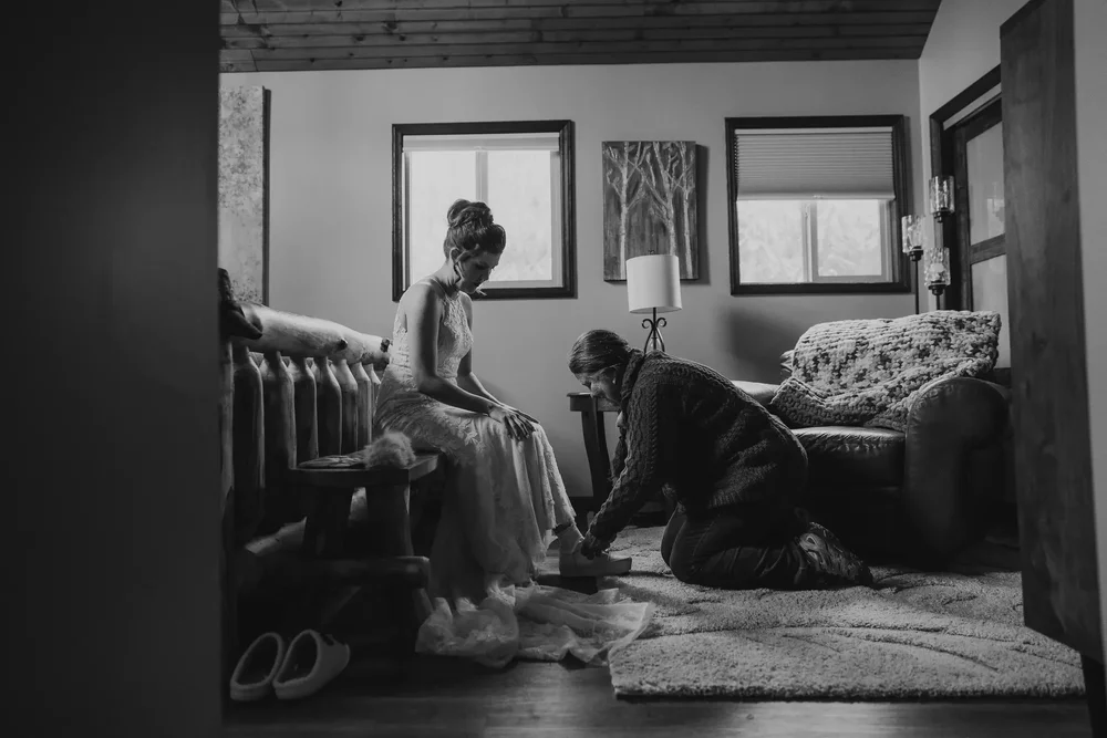 Bride getting ready with a family member before her elopement