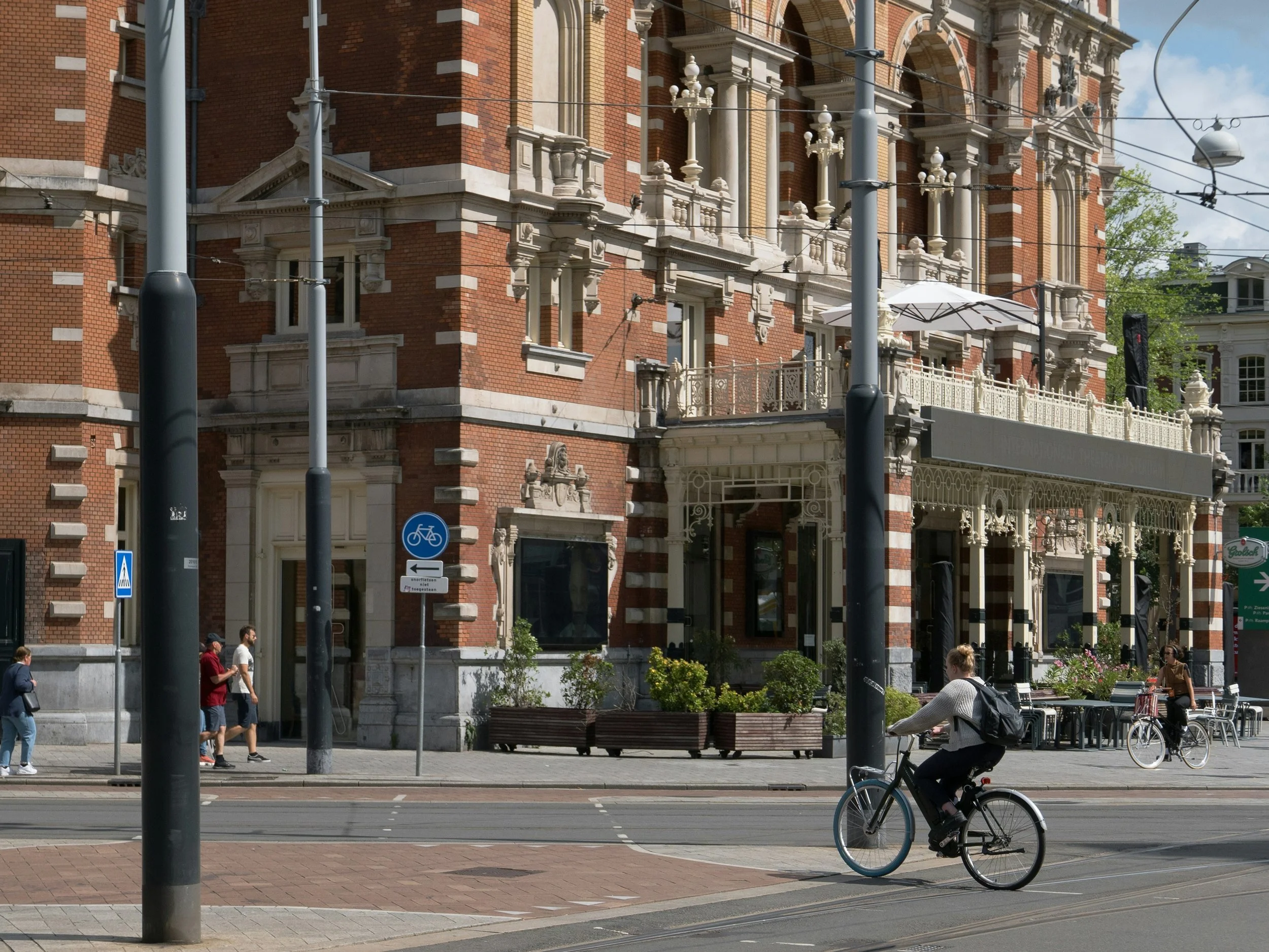 A person crossing the road on a bike. Photo by Fons Heijnsbroek on Unsplash.