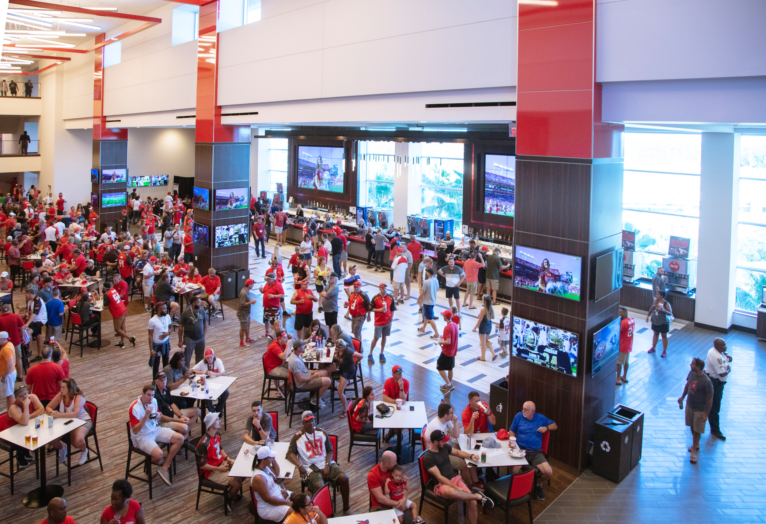 Seen from abaove fans gather around tables in the Hyundai Club.