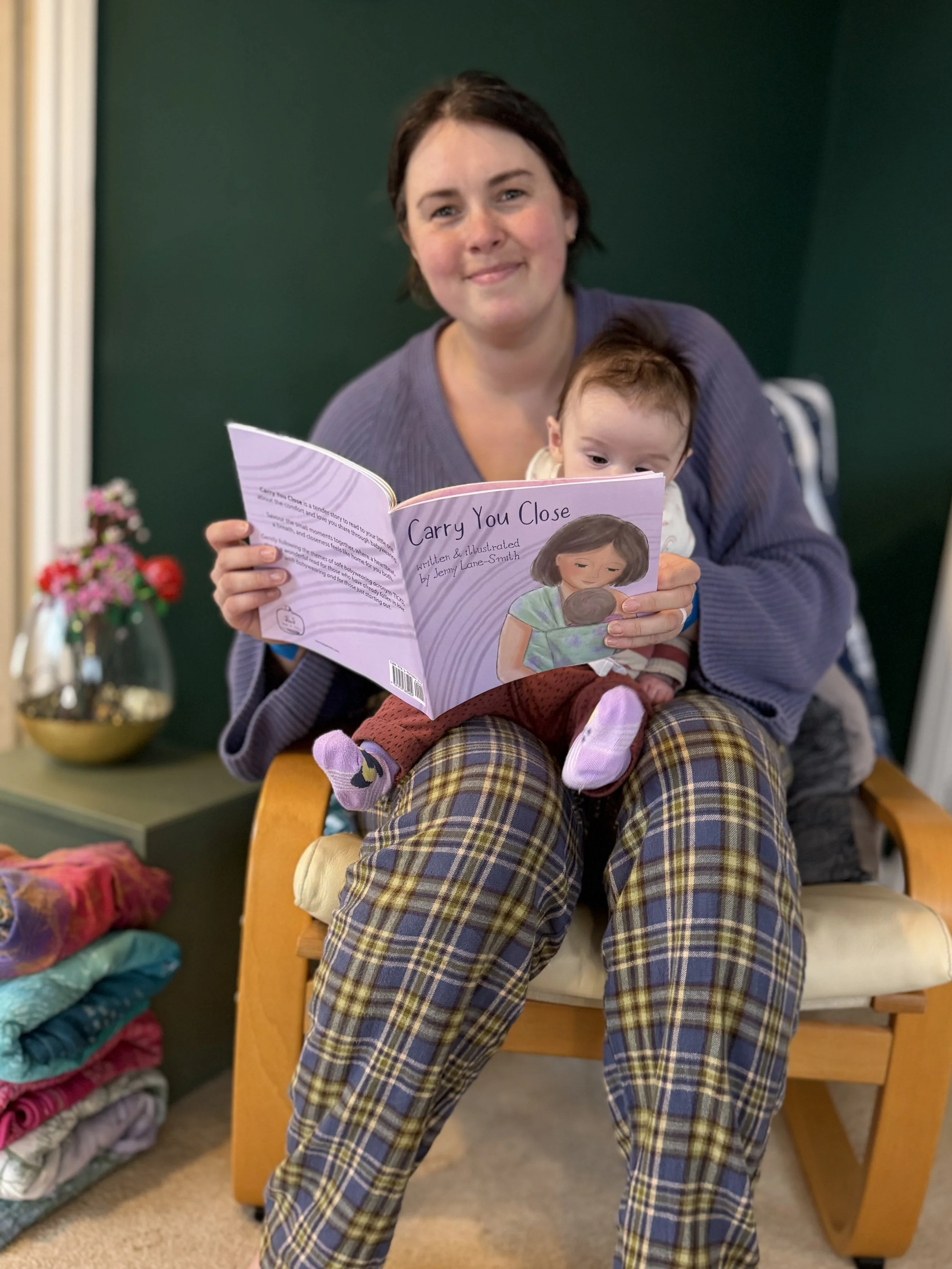 parent and baby reading Carry You Close book together