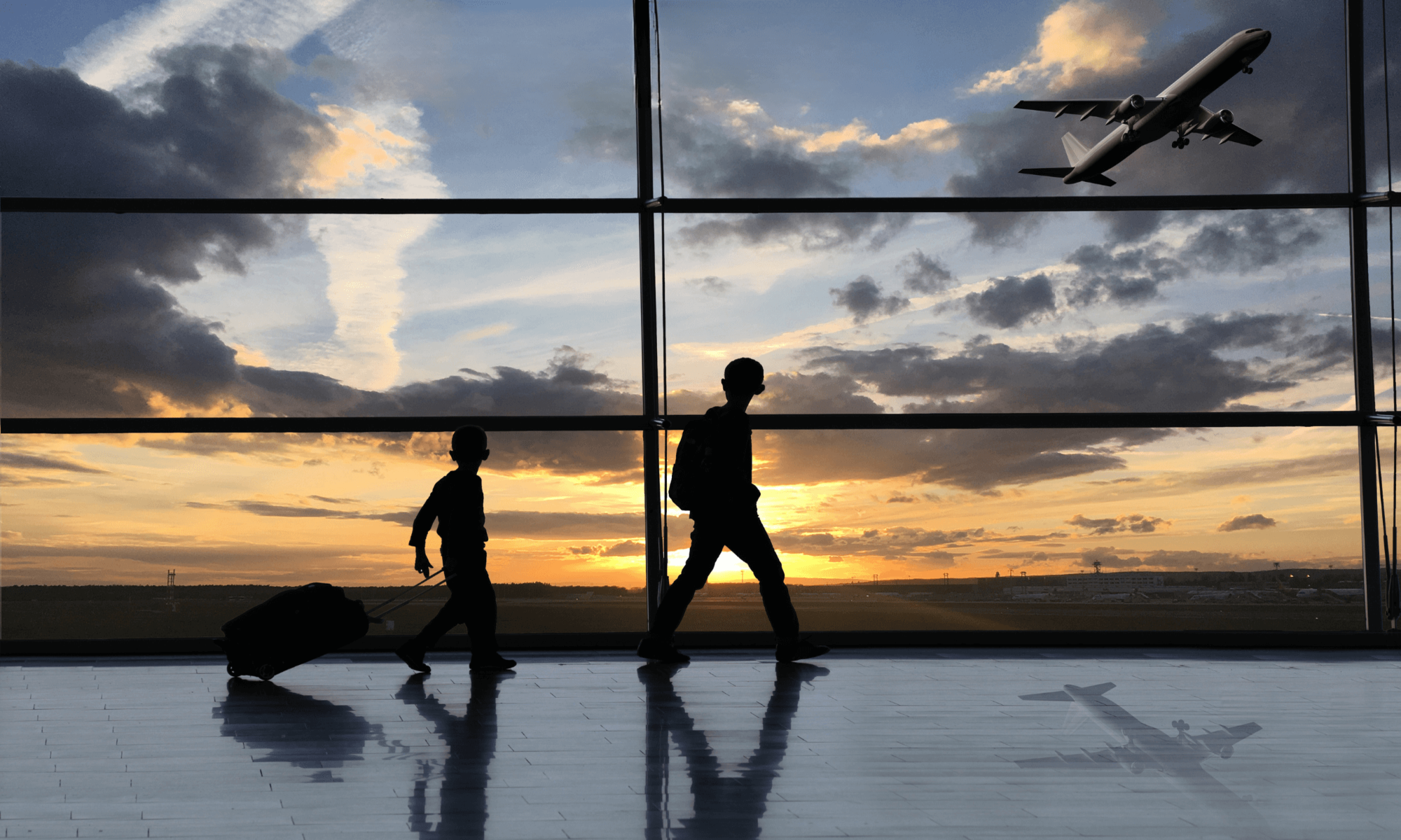 Silhouettes of travelers in an airport with a plane taking off at sunset, reflecting immigration, displacement, and cultural transition