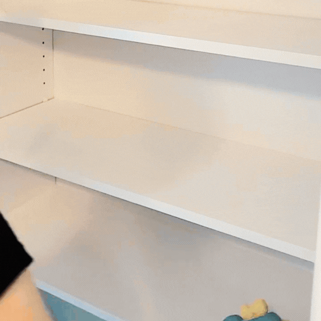 Cleaning in progress at Toronto condo, wiping inside cupboards in a kitchen for a move out cleaning.