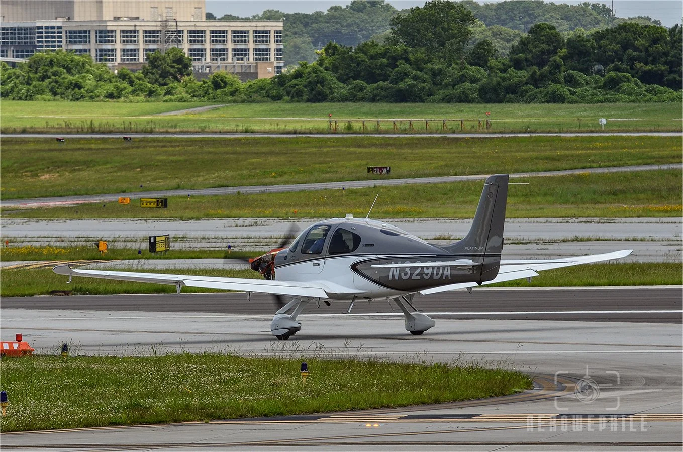 Cirrus SR20-G6 Platinum rolling down a taxiway on an engine test run. Note the missing engine cowling.