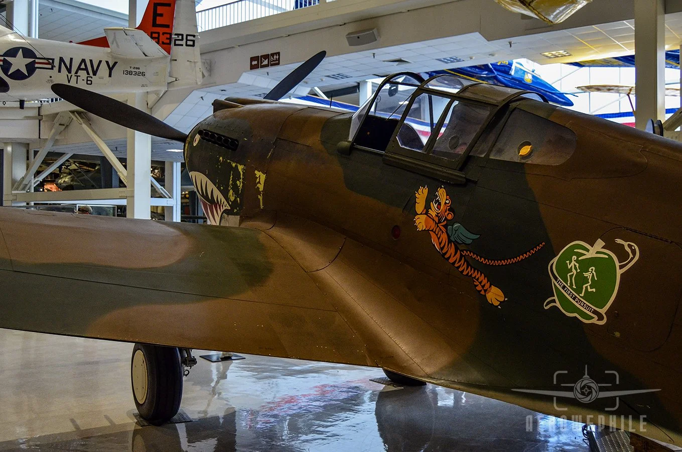P-40B Tomahawk with the Flying Tiger emblem and the 1st squadron's Adam and Eves logo painted on the fuselage.
