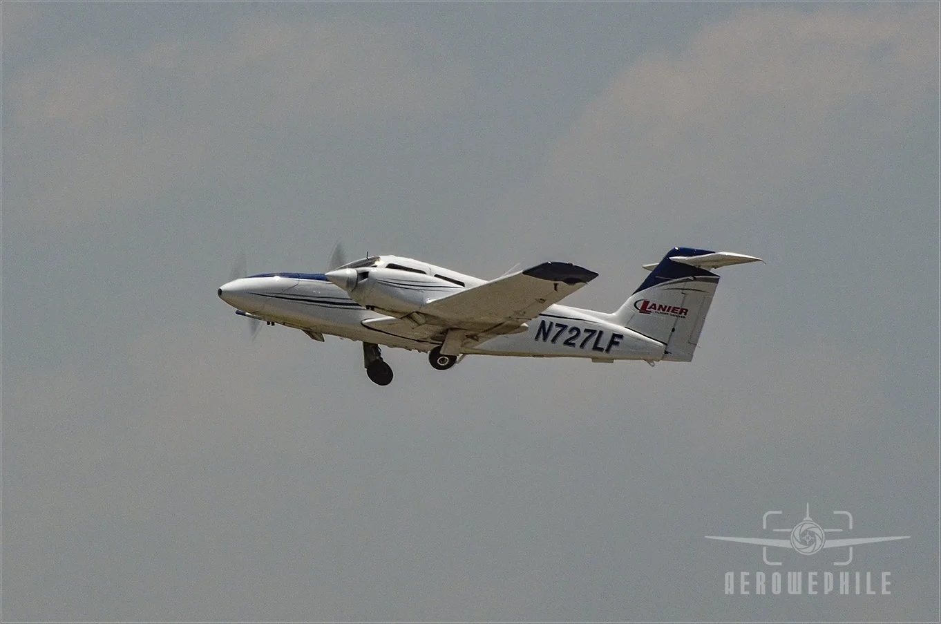 Piper PA-44-180 Seminole taking off with the gear coming up.