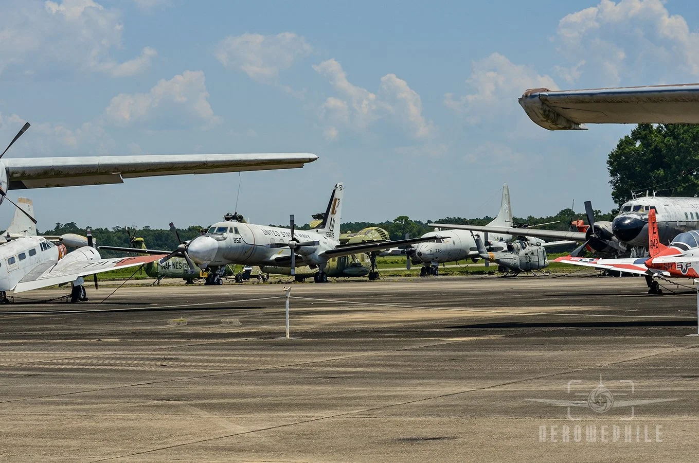 Grumman TC-4C Academe, P-3 Orion, UH-1 Huey, and a Sikorsky CH-37 Mojave partially visible in the back.