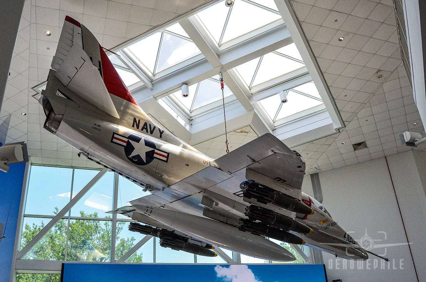 A-4E Skyhawk (Bureau Number 149656) suspended in the Quarterdeck honors Attack Squadrons (VA) 163 and 164.