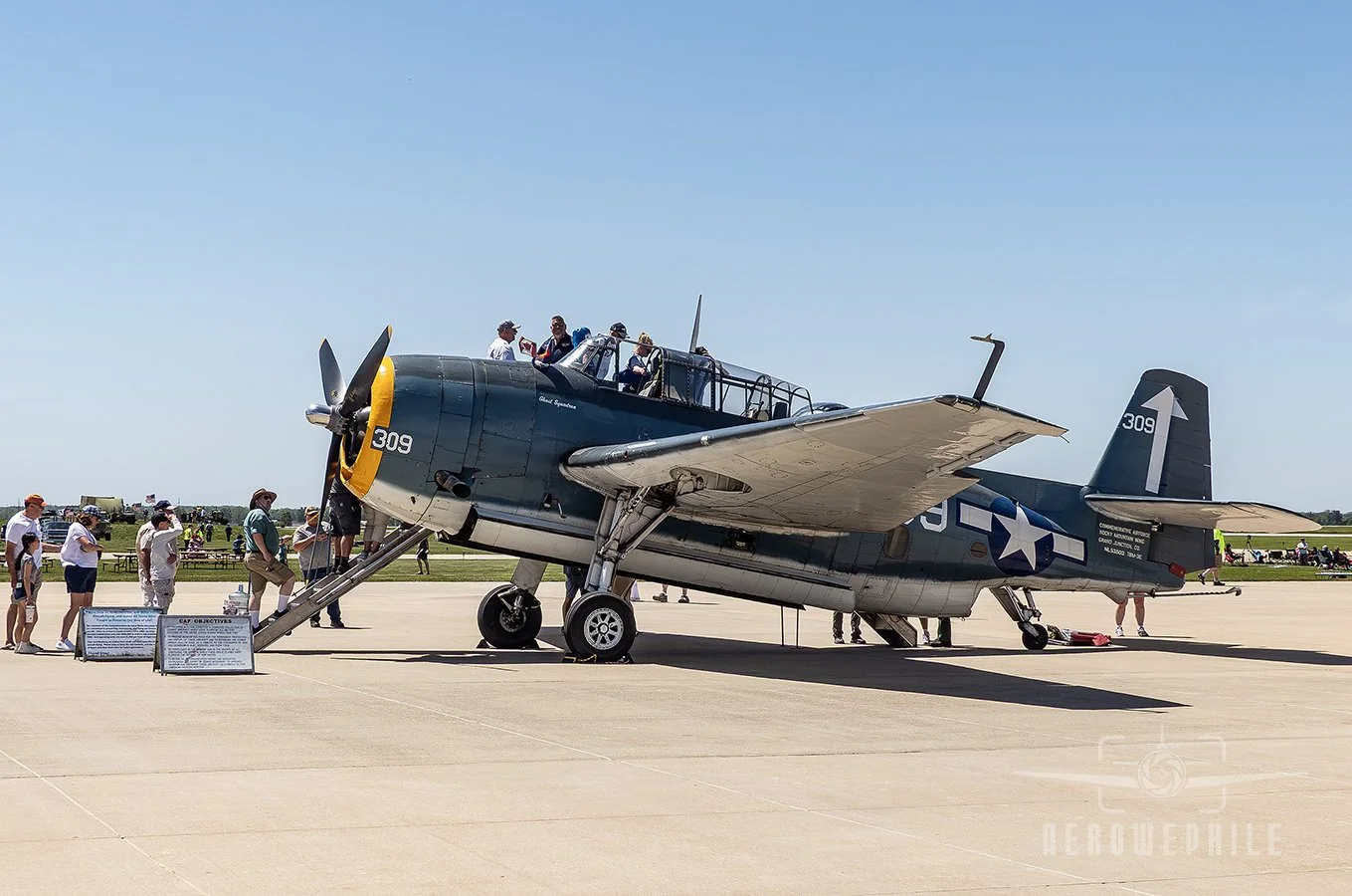 Folks lined up to view the Commemorative Air Force's TBM Avenger.