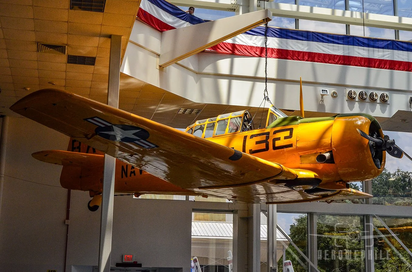 Delivered in 1943, the SNJ-5C Texan on display (Bureau Number 51849) spent most of its service life at Naval Air Station (NAS) Pensacola and surrounding airfields, but also flew as a utility aircraft aboard the aircraft carrier Kearsarge (CVS-33).