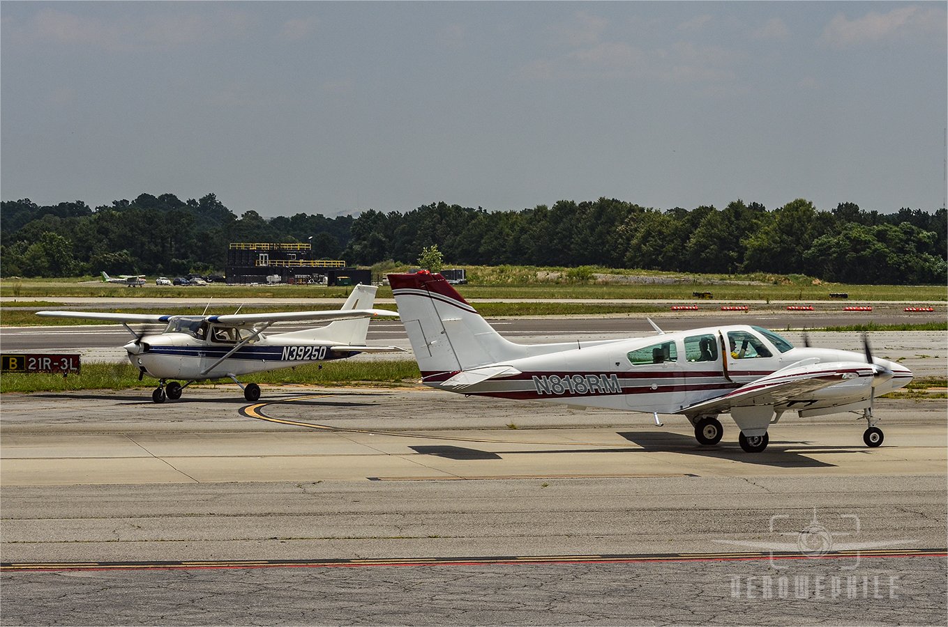 Beechcraft E55 Baron and a Cessna on the taxiways.