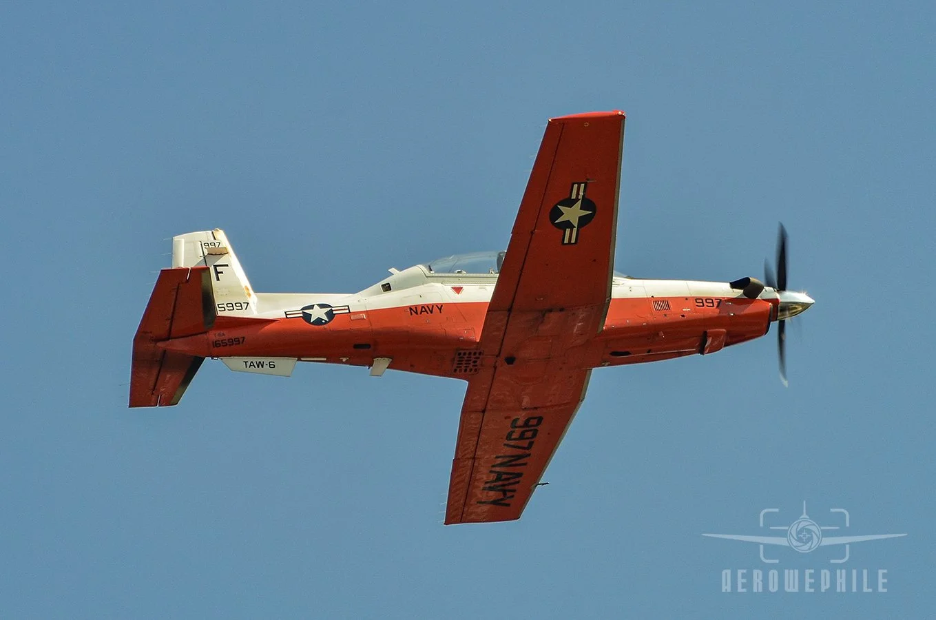 U.S. Navy Beechcraft T-6 Texan II passing overhead.