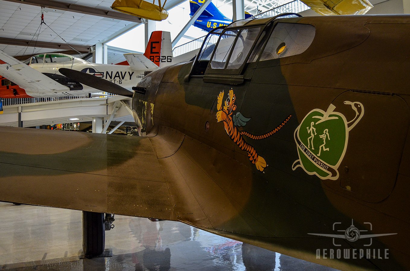 P-40B Tomahawk with the Flying Tiger emblem and the 1st squadron's Adam and Eves logo painted on the fuselage.