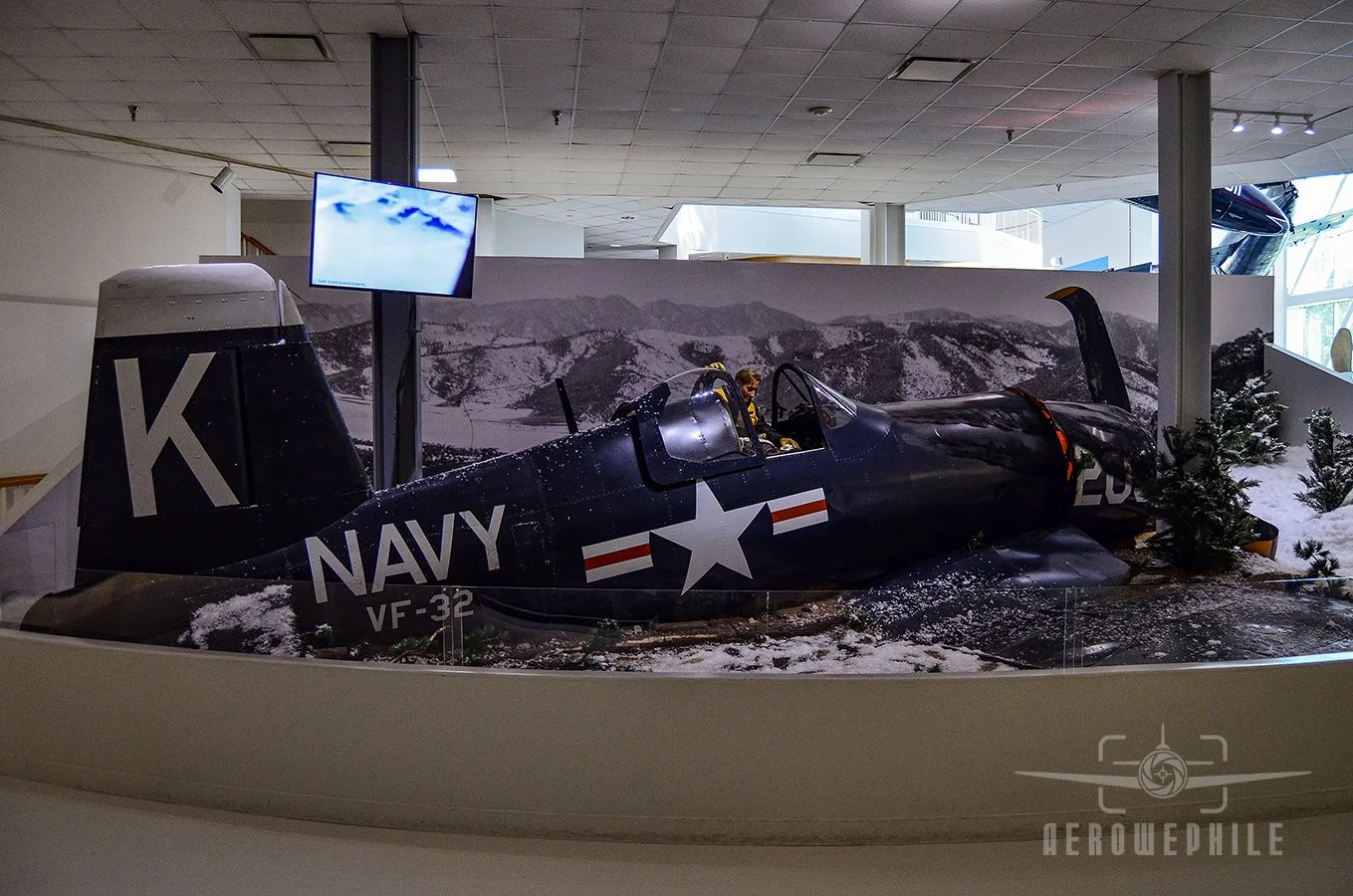 The rescue action, for which LTJG Thomas Hudner Jr received the Medal of Honor, was the subject of a book and motion picture titled Devotion. The replica F4U-4 that is the centerpiece of the diorama depicting the snowy North Korean landscape around t