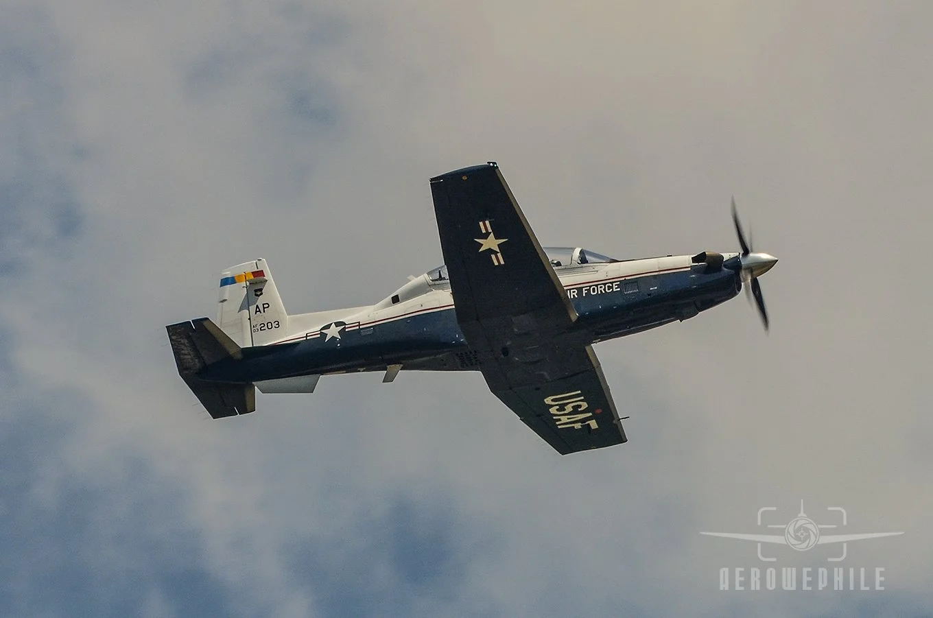 A  second U.S. Air Force Beechcraft T-6 Texan II passing overhead at the naval air station.