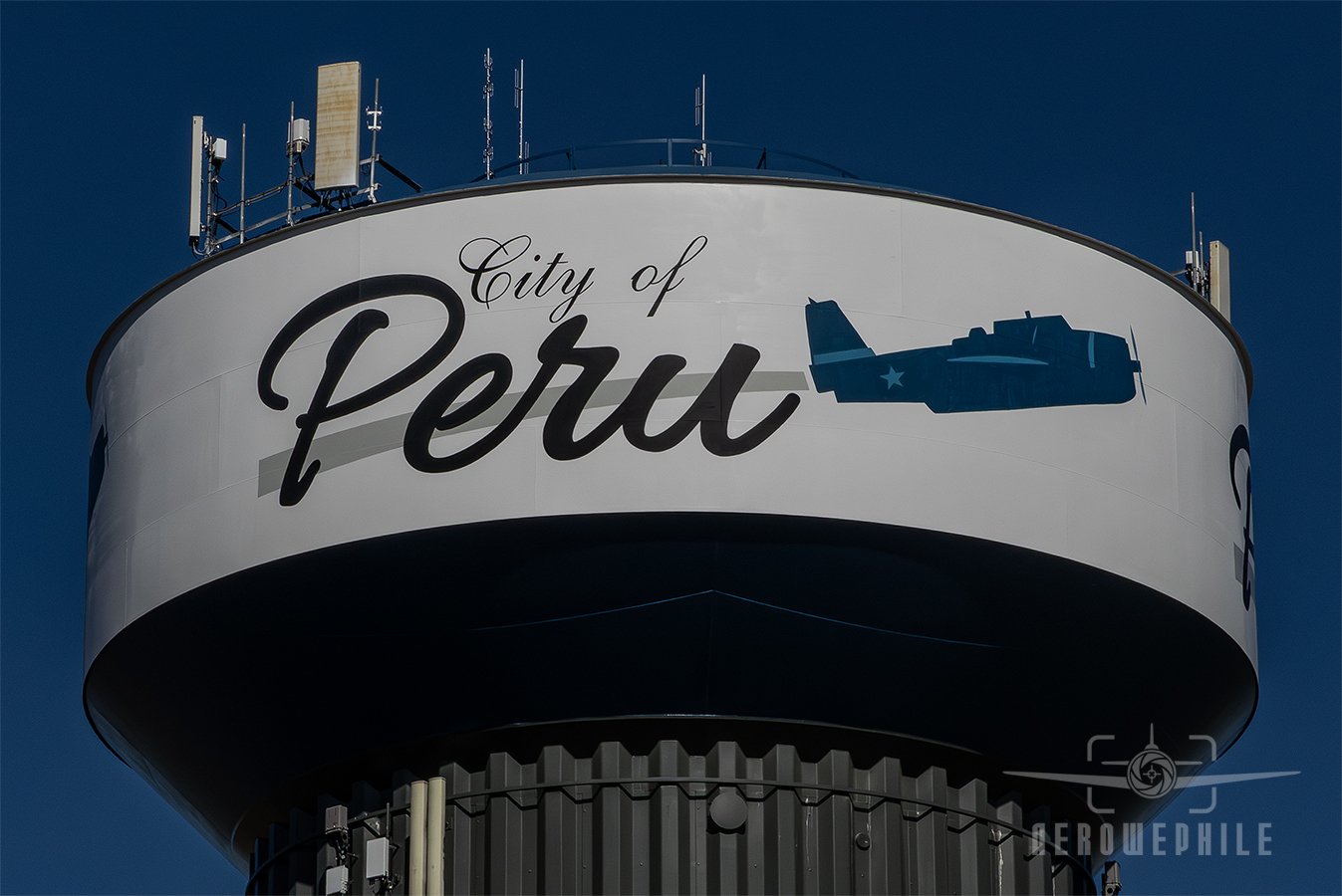Daytime closeup of the Peru, Illinois water tower with a TBM Avenger painted on the side.