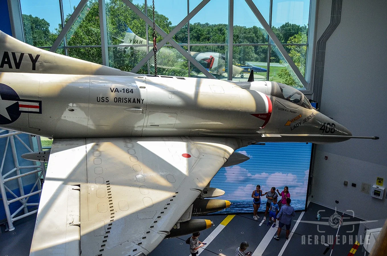A-4E Skyhawk (Bureau Number 149656) suspended in the Quarterdeck honors Attack Squadrons (VA) 163 and 164.