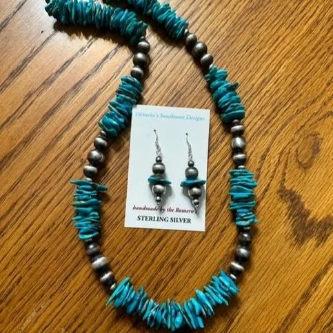 Beaded necklace and matching earrings with silver, turquoise, and metallic beads on a wooden surface