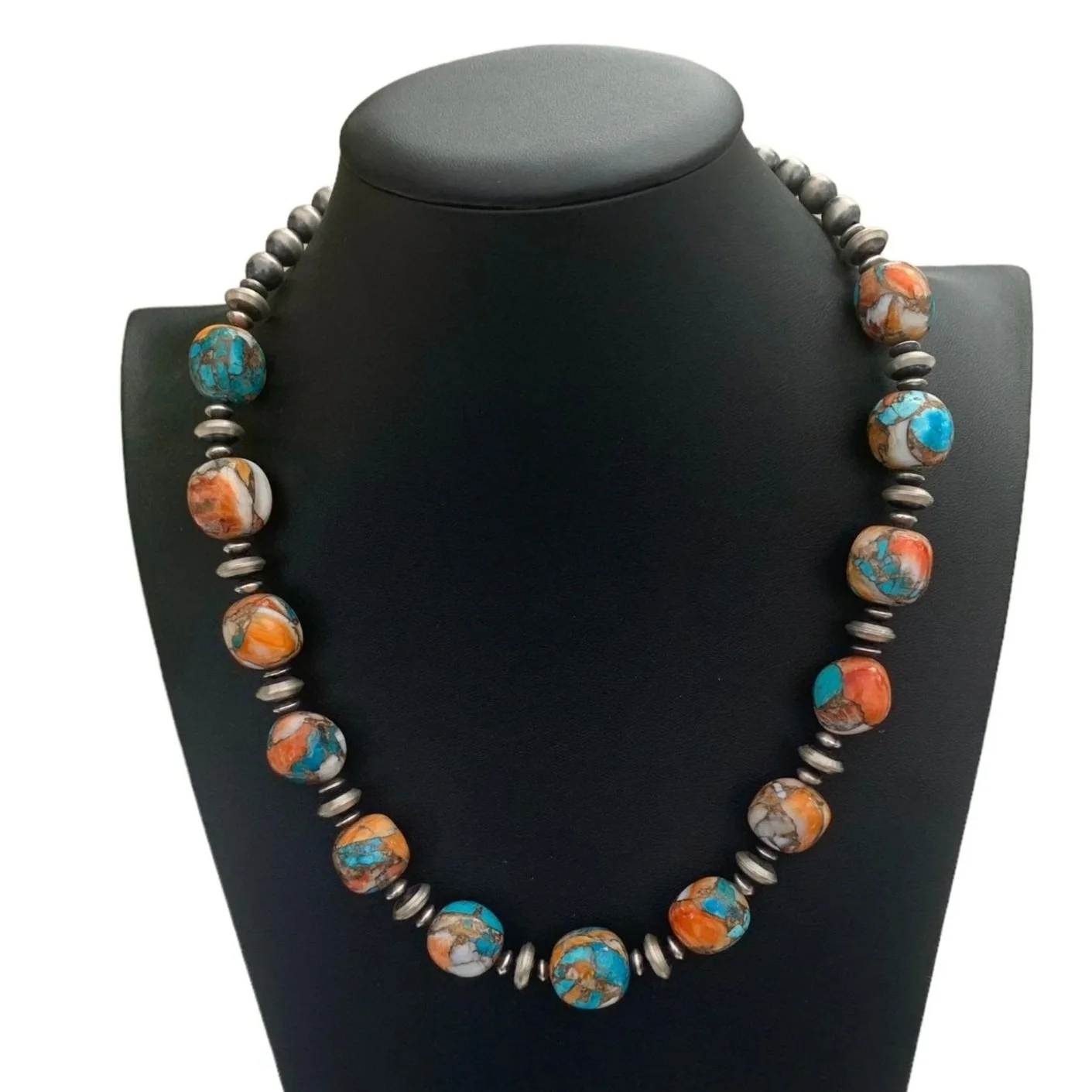 Beaded necklace with turquoise and orange stones displayed on a black jewelry bust, labeled 'Victoria's Southwest Designs'.
