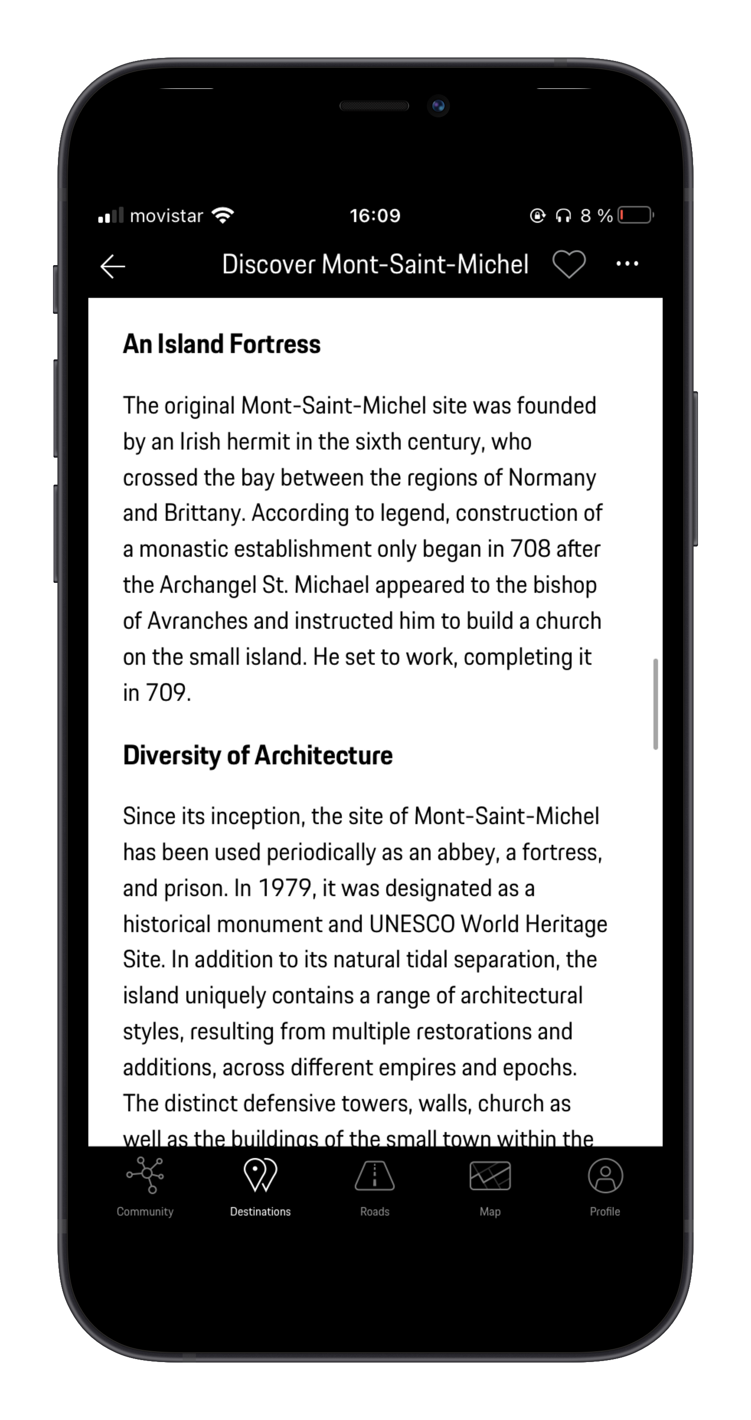 Smartphone screen showing a travel app with information about Mont-Saint-Michel, including its history, architecture, and significance as a UNESCO World Heritage Site.