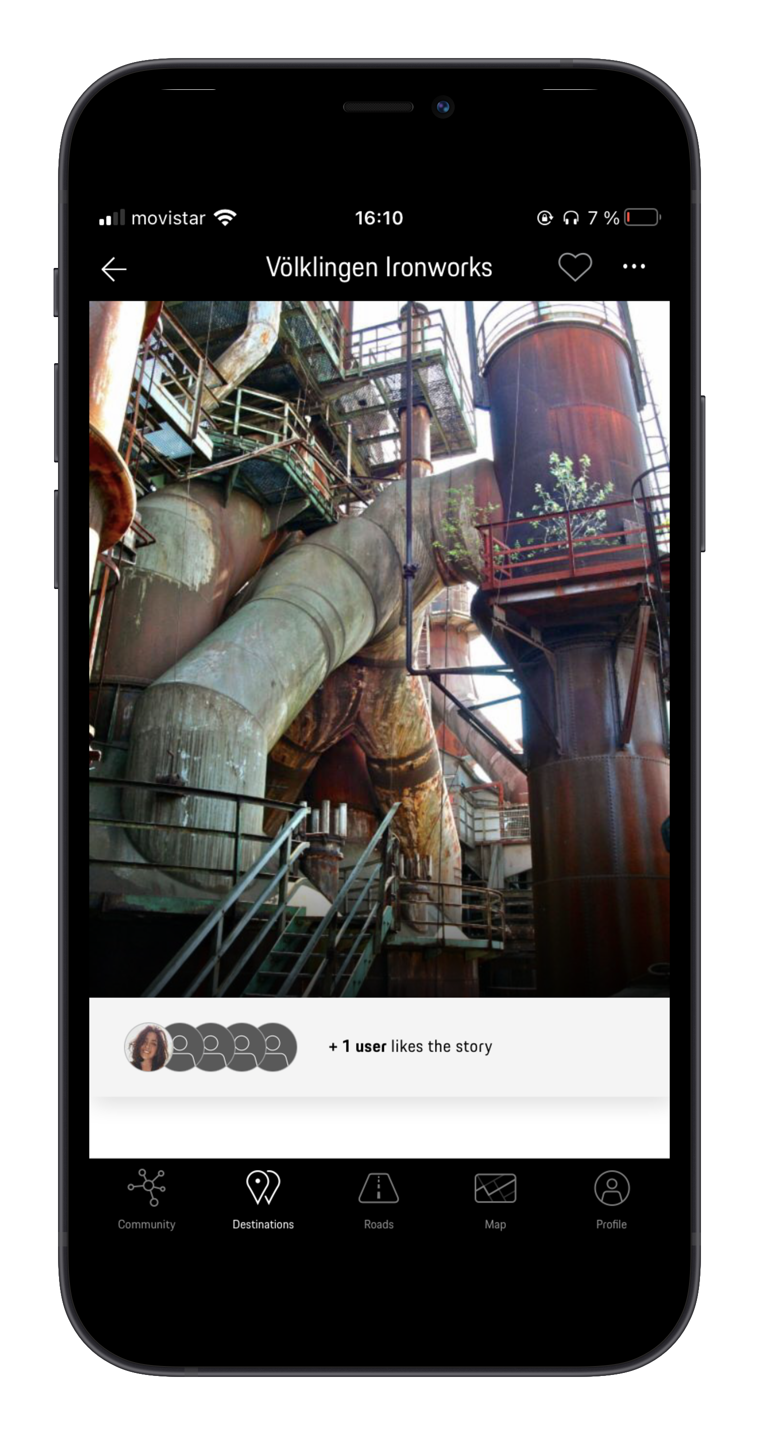 Rusty industrial plant with large metal pipes and escalators.