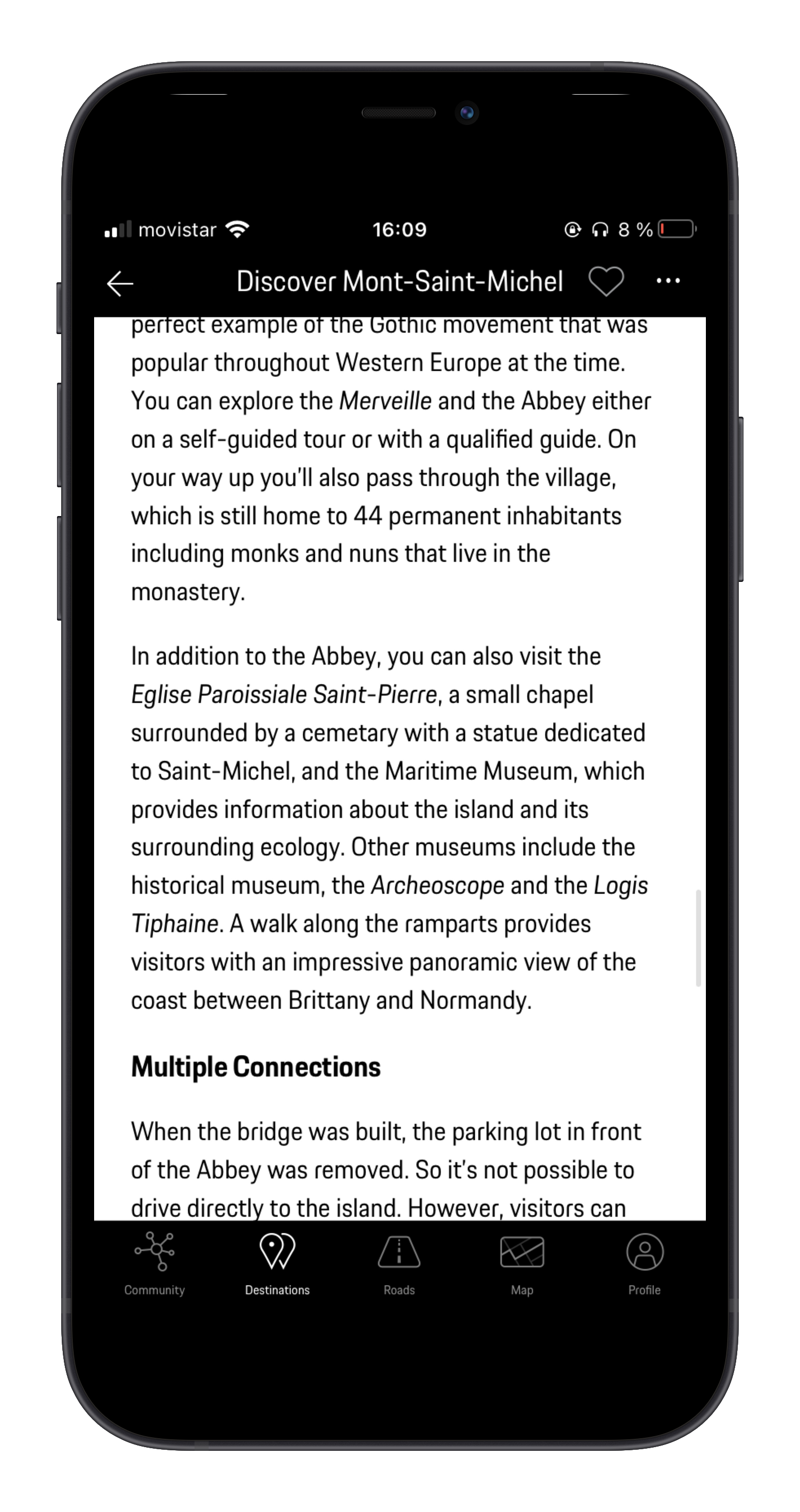 Mobile phone screen displaying a travel guide about Mont-Saint-Michel with text about its history and nearby attractions.