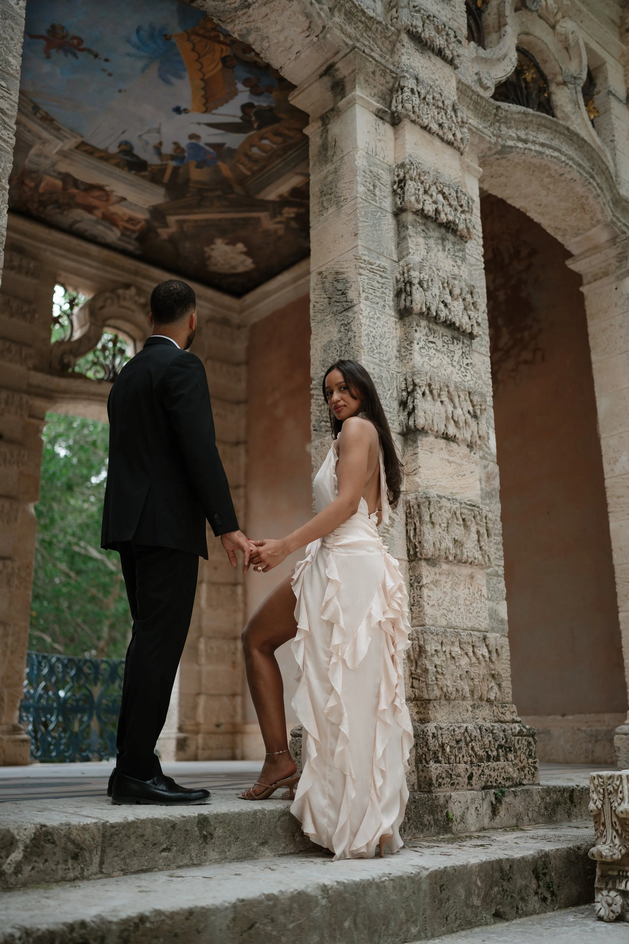 At Vizcaya Museum & Gardens, this engagement session captures romantic moments between a couple surrounded by timeless European-inspired architecture and lush tropical gardens in Miami. Elegant, candid, and editorial-style photography by a Miami wedd