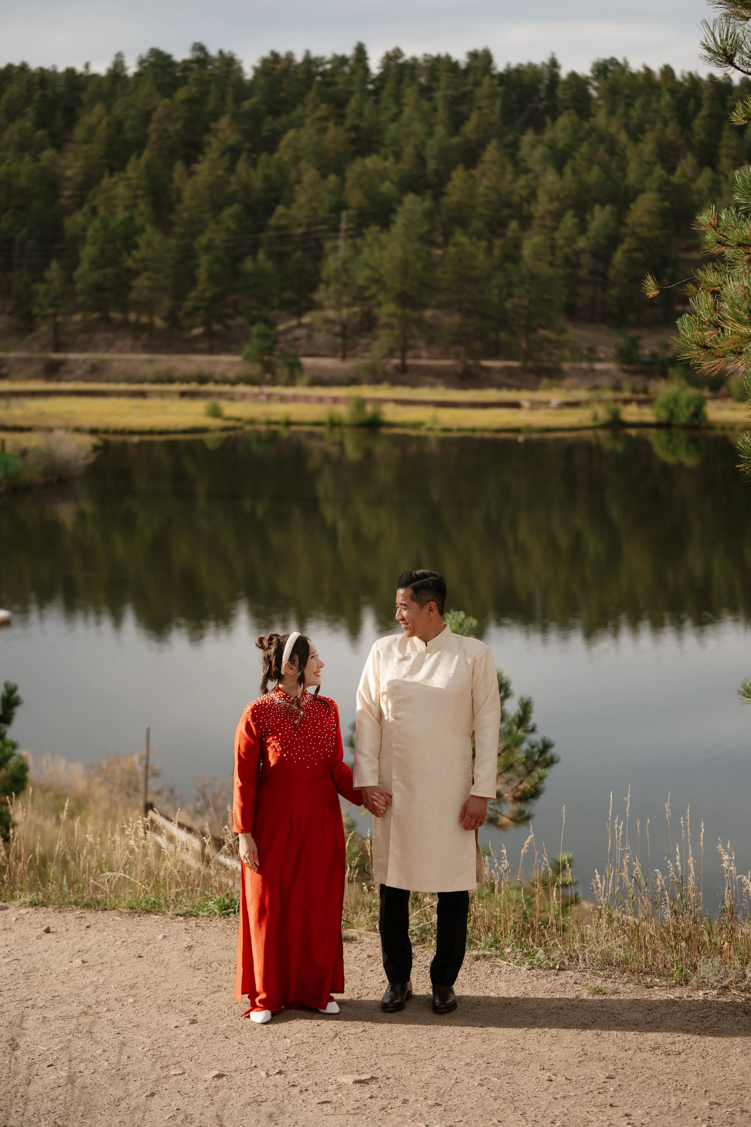 Adventure-inspired engagement session in Colorado featuring a couple surrounded by breathtaking mountain landscapes, golden light, and natural scenery. Authentic and emotional engagement photography with a cinematic outdoor aesthetic.