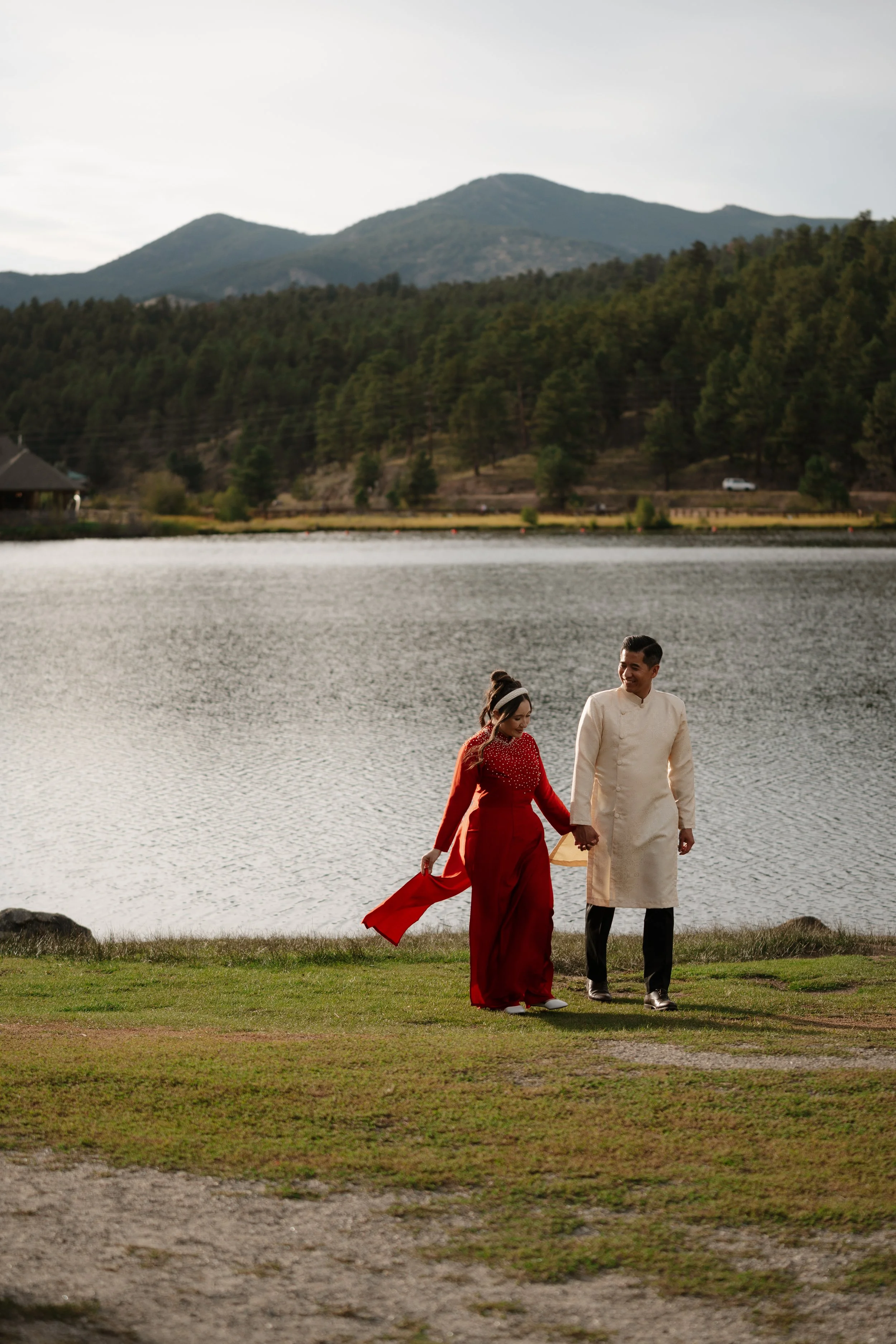 Adventure-inspired engagement session in Colorado featuring a couple surrounded by breathtaking mountain landscapes, golden light, and natural scenery. Authentic and emotional engagement photography with a cinematic outdoor aesthetic.