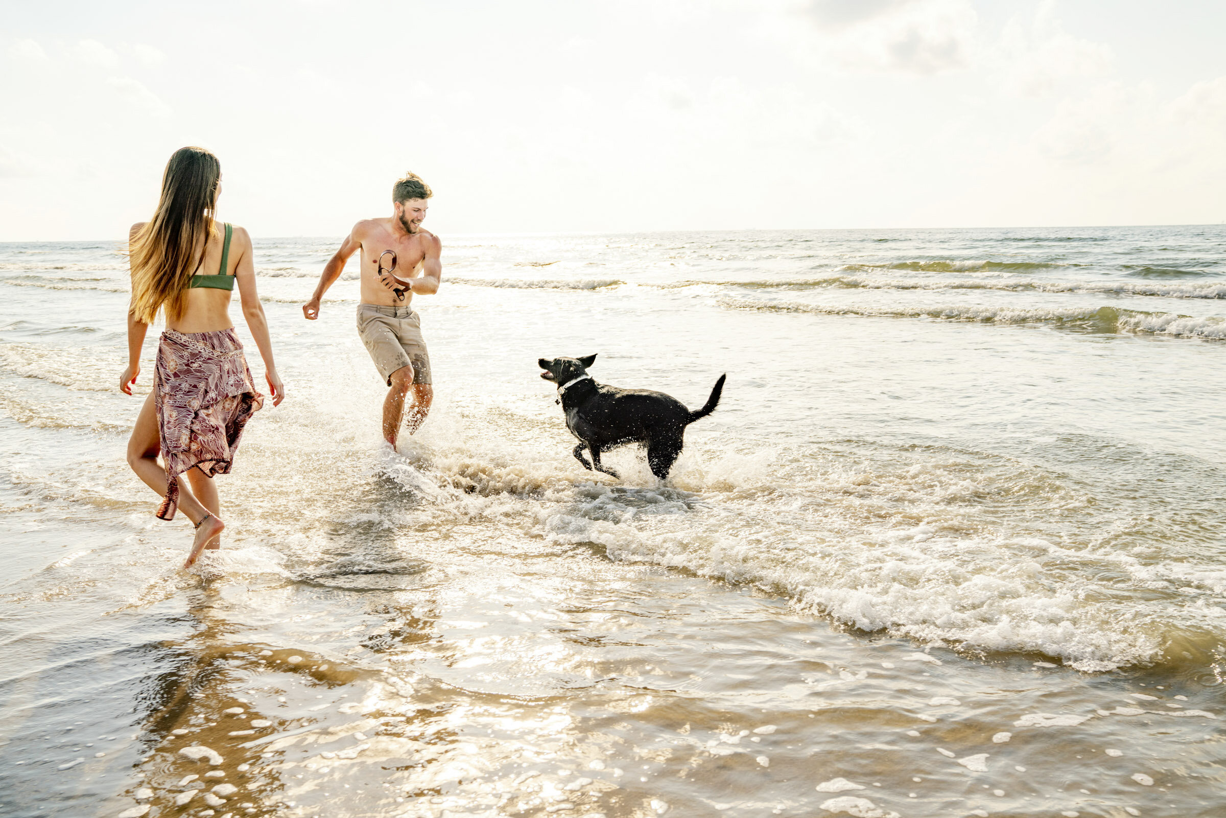 Couple-playing-with-dog-in-ocean-Inti-St-Clair-Lifestyle-is20190612_Palmilla_2813.jpg