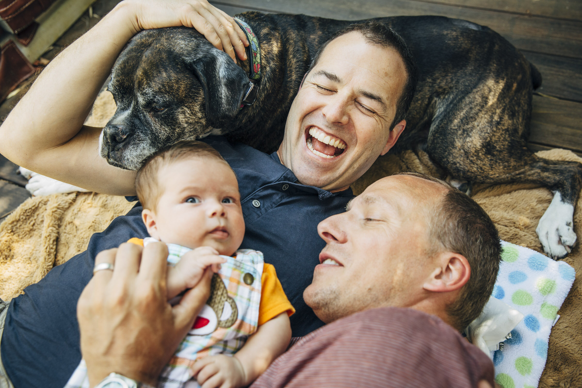 Gay-dads-snuggling-dog-baby--Inti-St-Clair-Lifestyle-is2014080300808.jpg