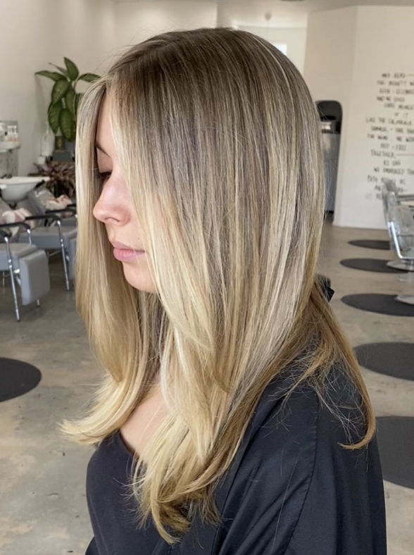 Side view of a woman with long, blonde hair with subtle highlights in a modern salon, The Ministry Salon in Silver Lake or Studio City, Los Angeles