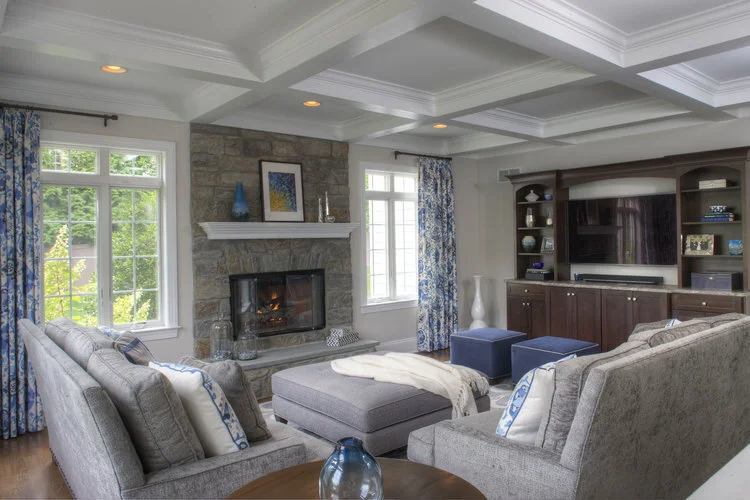 family room with built ins, custom built ins, tv wall , blue, ikat rug, ikat, hand knotted rug, custom drapery, Robert Allen, Vanguard furniture, custom home, grey, velvet, chenille sofa, ottoman, cobalt, Arteriors, stone fireplace, stonework, masonr