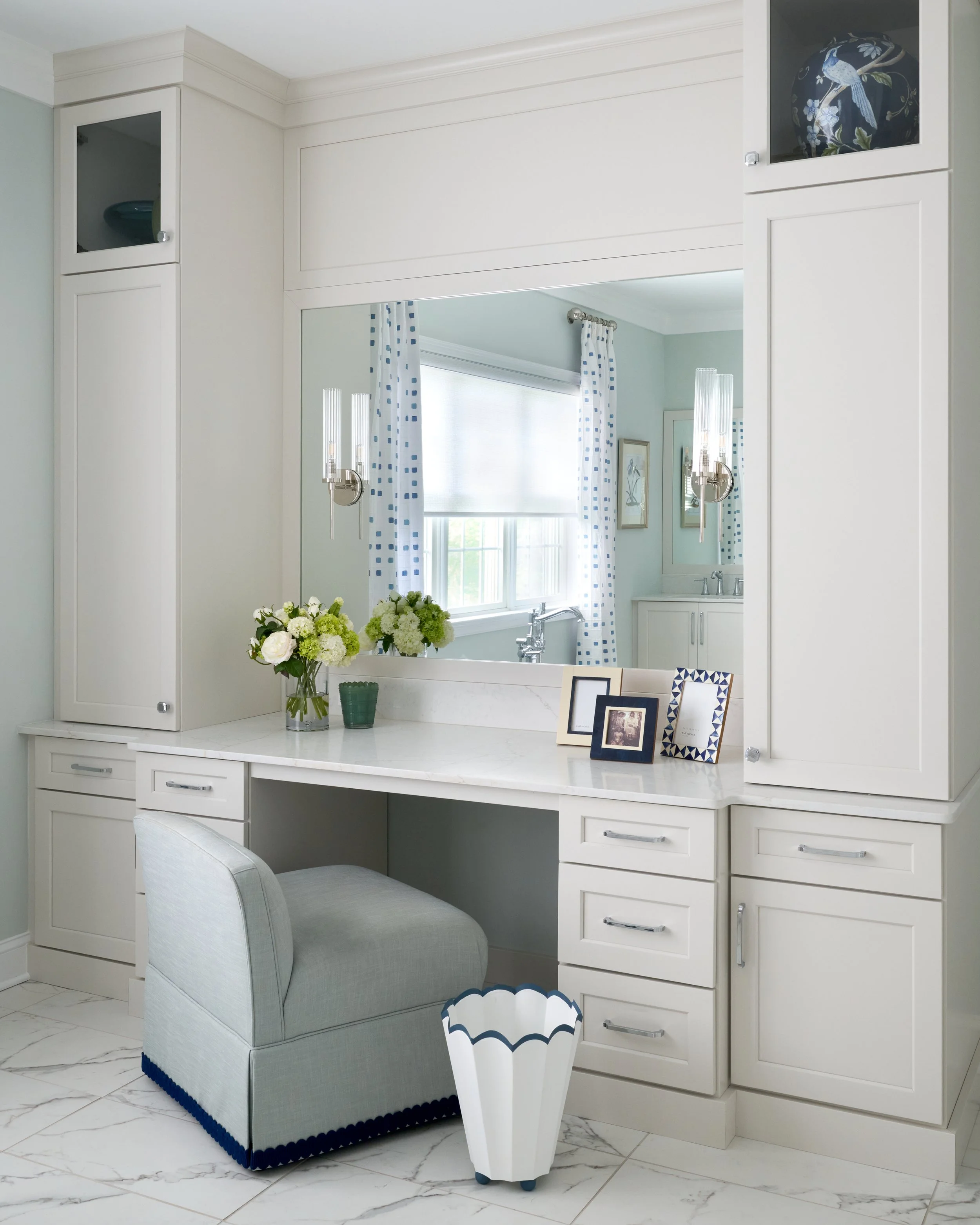 light bright airy clean sleek soothing primary bathroom with double vanity, elegant chandelier, patterned drapery, and free standing soaking tub